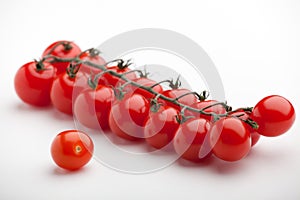 Red cherry tomatoes close-up white background