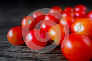 Red Cherry Tomatoes closeup on dark wood