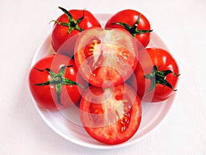 Red cherry tomatoes fruit vine tomato vegetable 
tamaatar tomat timatar pomidor tomate whole and halved closeup view image photo