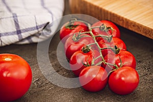 Red cherry tomatoes in kitchen, close up detail