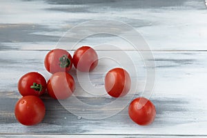 Red cherry tomatoes on a wooden background salad ingredients