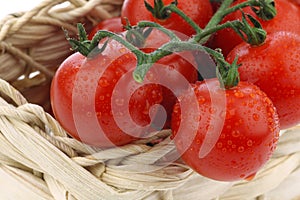 Red cherry tomatoes in a woven basket