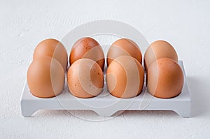 Red chicken eggs on a white background.