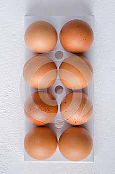 Red chicken eggs on a white background.