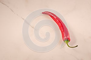 red Chile on white marble table/red Chile on white marble background. Close up