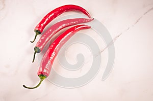 red Chile on white marble table/red Chile on white marble background. Top view.  Copy space