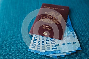 A red Chilean passport with Chilean money