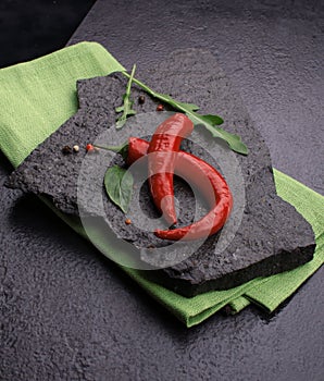 red chili pepper on black slate