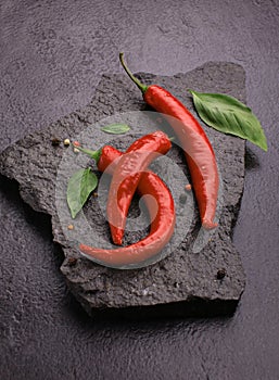 red chili pepper on black slate