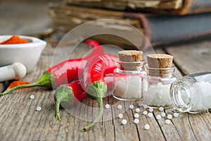 Red chili pepper and bottles of homeopathic globules. Homeopathy