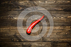 Red chili pepper on plate on wooden background