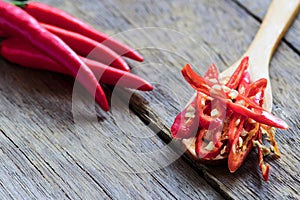 Red chili pepper slices on wooden spoon