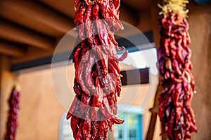 Red chili peppers dried hanging on a traditional building entrance, Santa Fe New Mexico