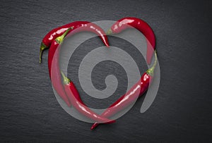 Red chili peppers heart for valentine's day. photo