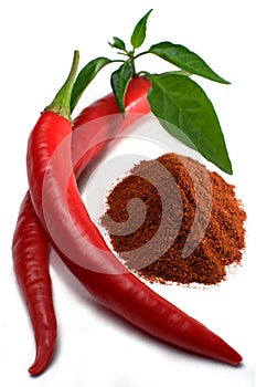 Red chili peppers with leaves and chili powder