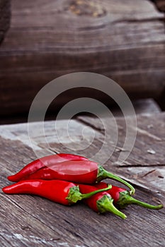 Red chili peppers on a wooden table