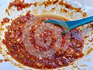 red chili sauce in white bowl