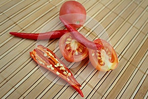 Red chili with tomatoes on wood background