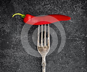 Red chili on a vintage fork with a patina photo