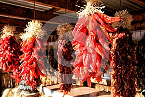 Red chilies hanging from the rafters to dry.