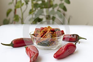 Red chilli pickle in transparent glass bowl photo