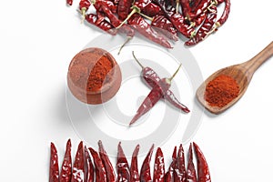 Red chilli powder with dried red chillies. in earthen bowl