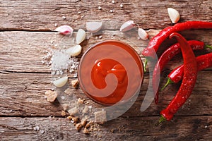 Red chilli sauce Sriracha with ingredients. horizontal top view