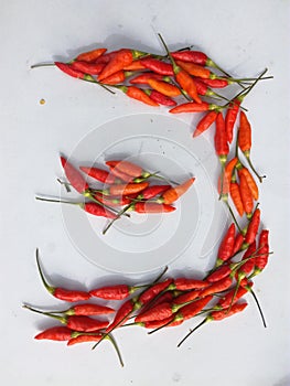 Red chillies on a white background. Can be used for badges.
