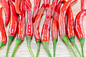 Red Chillis on wooden top photo
