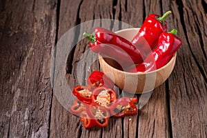 Red chilly pepper on wooden black background. Red hot chili peppers.