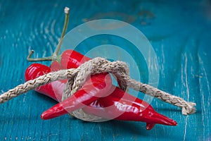 Red chilly peppers on a wooden table