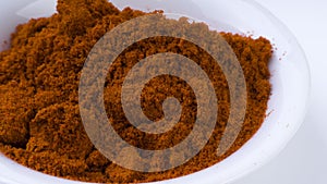 Red Chilly Powder in a bowl on white background.Selective focus and crop fragment.