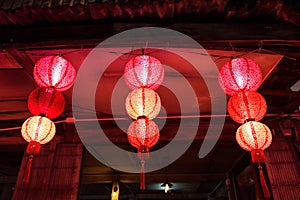 Red Chinese lamps in wooden house