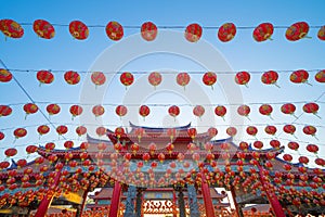 Red chinese lanterns hanging on wire outdoor lamps in temple of China Town decoration on Chinese New Year festival culture with