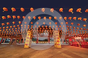 Red chinese lanterns hanging on wire outdoor lamps in temple of China Town decoration on Chinese New Year festival culture with