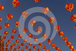 Red chinese lanterns hanging on wire outdoor lamps in temple of China Town decoration on Chinese New Year festival culture with