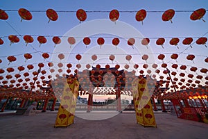 Red chinese lanterns hanging on wire outdoor lamps in temple of China Town decoration on Chinese New Year festival culture with