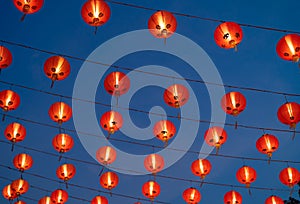 Red chinese lanterns hanging on wire outdoor lamps in temple of China Town decoration on Chinese New Year festival culture with