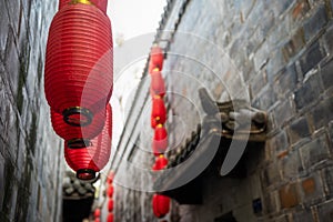 Red Chinese lanterns low angle view in a narrow alley