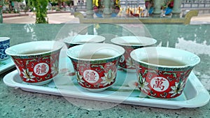 Red Chinese tea cup on shiny marble altar