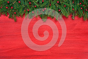 Red Christmas background. Christmas fir tree with decoration on red wooden background