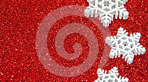 Red christmas background with snowflakes. Christmas New Year greeting card with sparkling glitter.