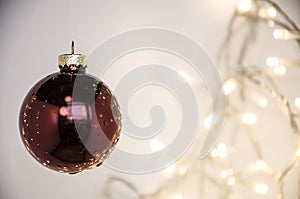 Red Christmas ball on the background of garland