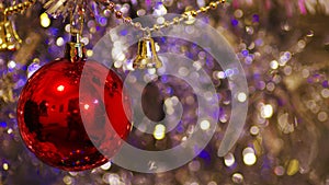 Red christmas ball decoration on glittering background. Dimension 16:9.