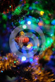 Red Christmas ball decoration hanged up on a Christmas tree with nice blurry background