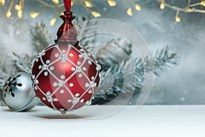 Red christmas ball with glowing led garland lights