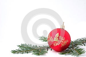 Red Christmas ball with green branch on white back