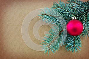 Red Christmas ball on green spruce branch isolated .