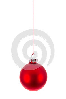 Red Christmas ball hanging at a rope over white