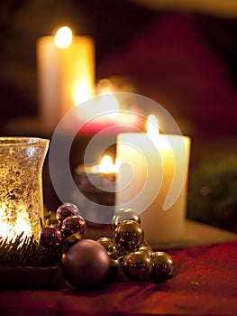 Red christmas ball ornaments with burning candles